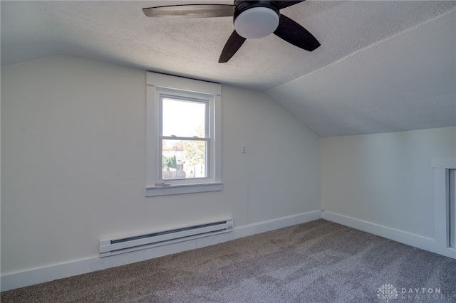 additional living space featuring a baseboard radiator, lofted ceiling, carpet floors, and a textured ceiling