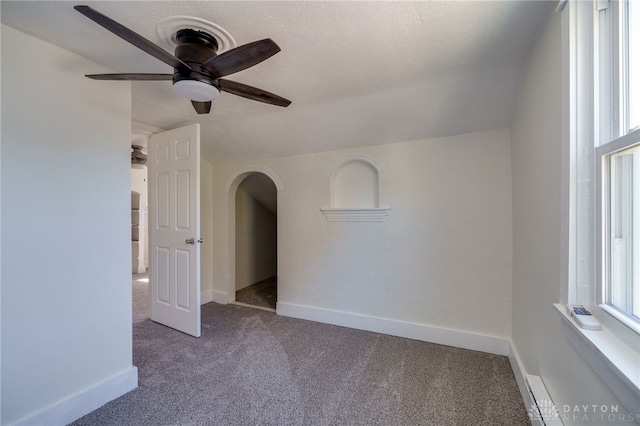 unfurnished room with ceiling fan, carpet floors, and a textured ceiling