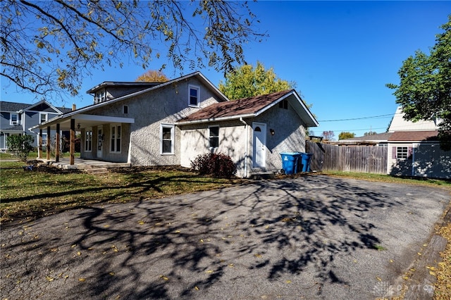 rear view of house with a patio area and a lawn