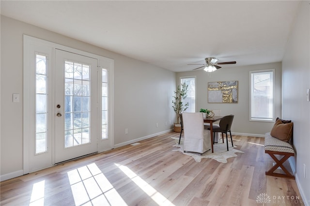 dining room with ceiling fan, plenty of natural light, and light hardwood / wood-style flooring