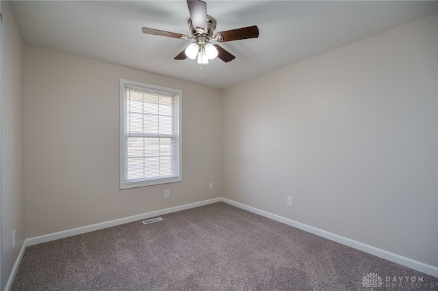 spare room featuring ceiling fan and carpet flooring