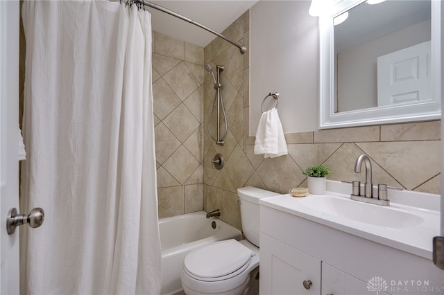 full bathroom featuring tile walls, vanity, toilet, and shower / bath combo