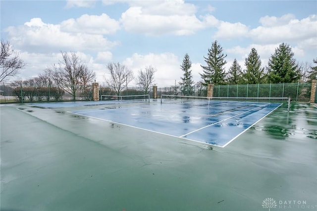 view of tennis court featuring fence