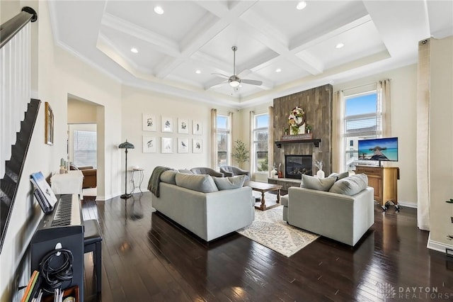 living room with a stone fireplace, coffered ceiling, baseboards, beam ceiling, and dark wood finished floors