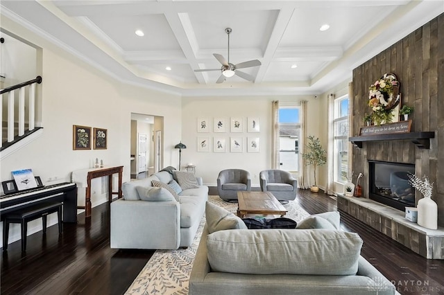 living area with a large fireplace, coffered ceiling, dark wood-style flooring, and beamed ceiling