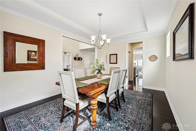 dining space with baseboards, a chandelier, dark wood-style flooring, and ornamental molding