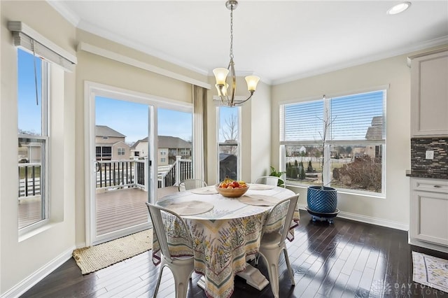 dining area featuring a healthy amount of sunlight, dark wood finished floors, and crown molding