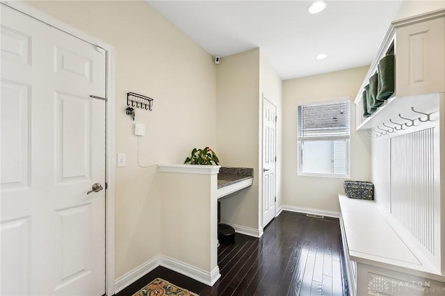 mudroom with dark wood-style floors, recessed lighting, and baseboards