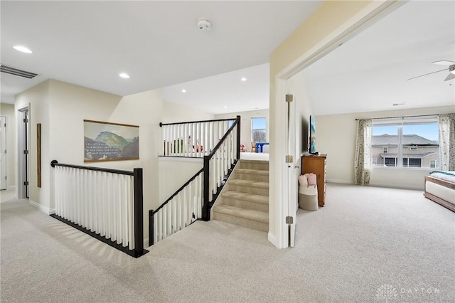 hall featuring recessed lighting, visible vents, carpet flooring, an upstairs landing, and baseboards