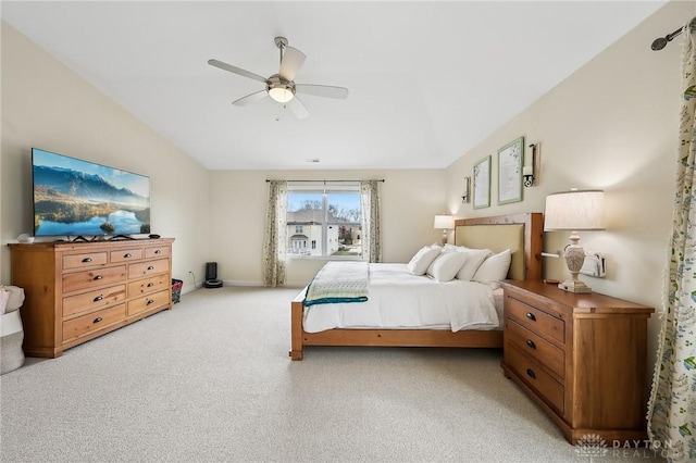 bedroom featuring light carpet, vaulted ceiling, and ceiling fan