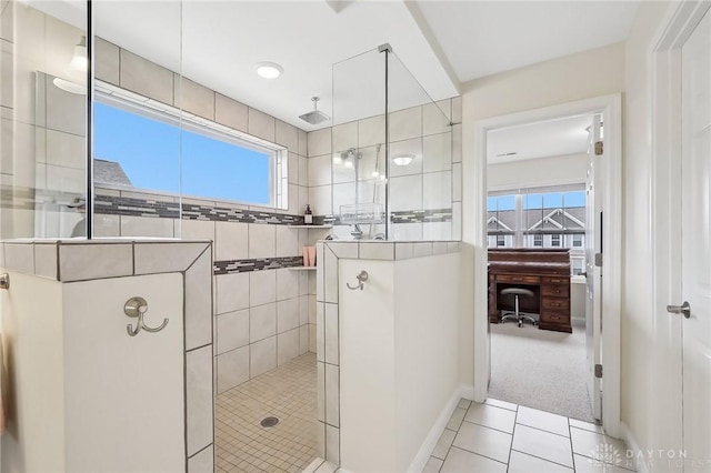 full bathroom featuring baseboards, walk in shower, and tile patterned floors