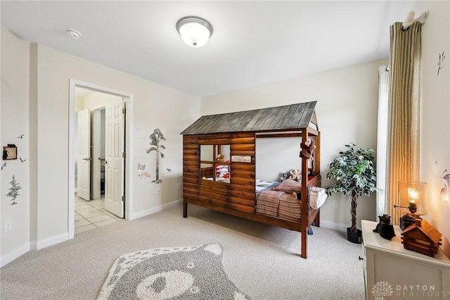 carpeted bedroom featuring baseboards