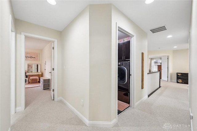 hall featuring carpet, washer / clothes dryer, visible vents, and baseboards