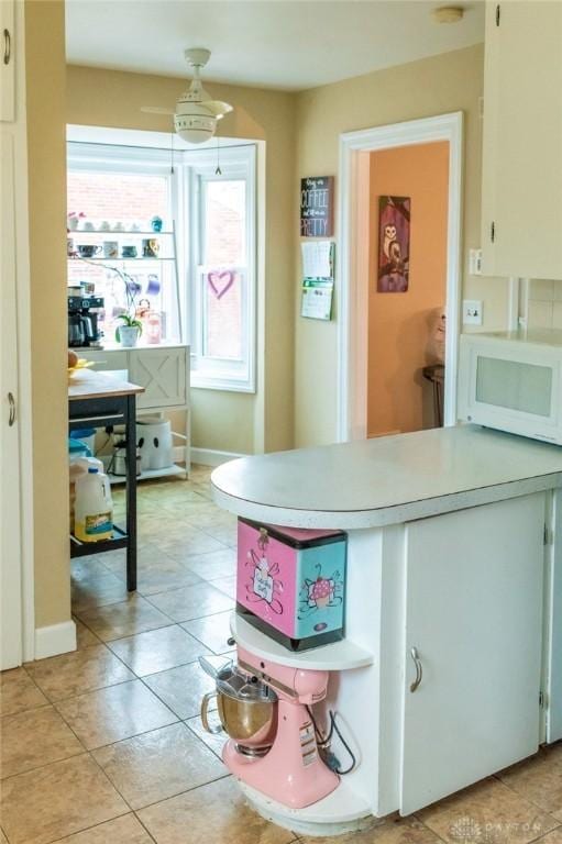 kitchen with white cabinetry and light tile patterned floors