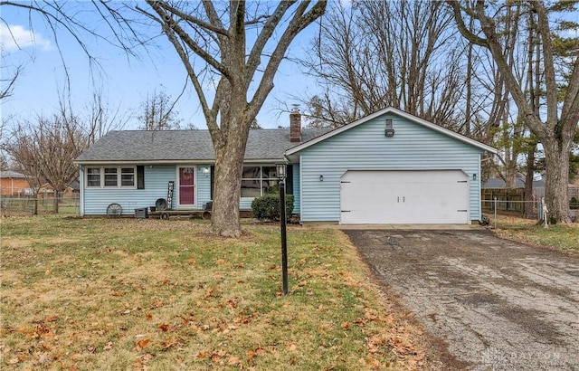 ranch-style home with a garage and a front lawn