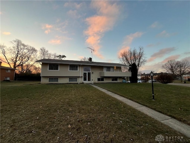 bi-level home featuring a yard