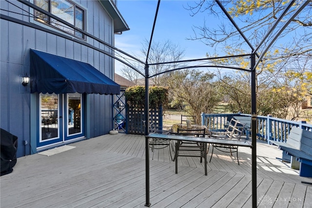 wooden terrace with outdoor dining space