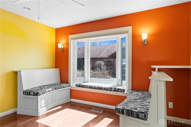 interior space with visible vents, baseboards, and wood finished floors