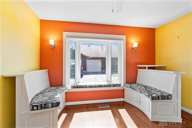 interior space with visible vents, baseboards, and wood finished floors