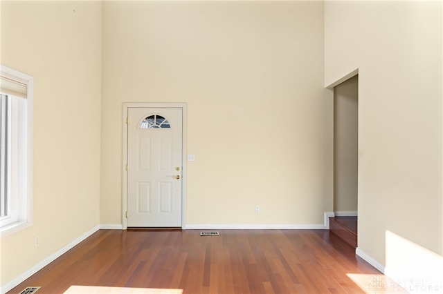 foyer with baseboards and wood finished floors