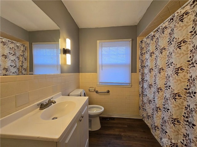 bathroom with hardwood / wood-style floors, curtained shower, tile walls, vanity, and toilet