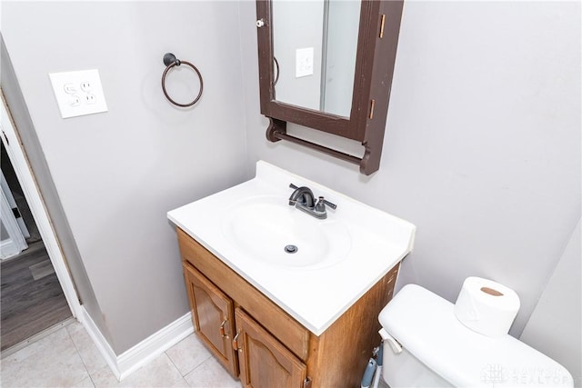 bathroom featuring tile patterned flooring, vanity, and toilet