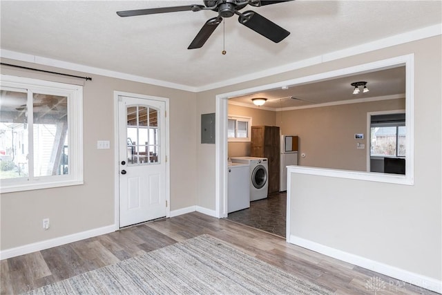 foyer with hardwood / wood-style flooring, electric panel, ceiling fan, crown molding, and washing machine and dryer