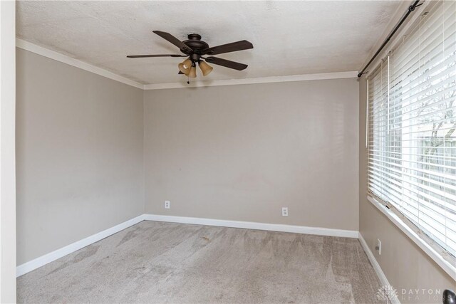 unfurnished room with crown molding, light colored carpet, and a textured ceiling