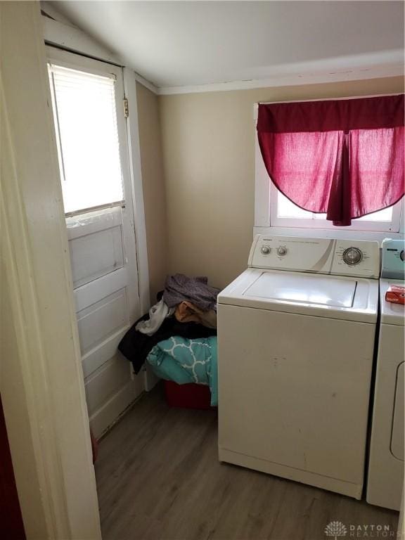 washroom featuring washer / dryer, a wealth of natural light, and light hardwood / wood-style flooring