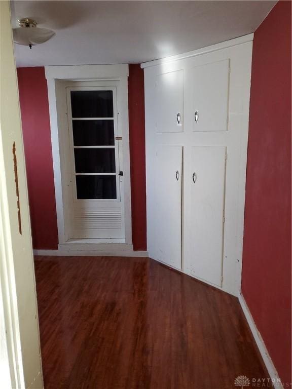 hallway with dark hardwood / wood-style floors