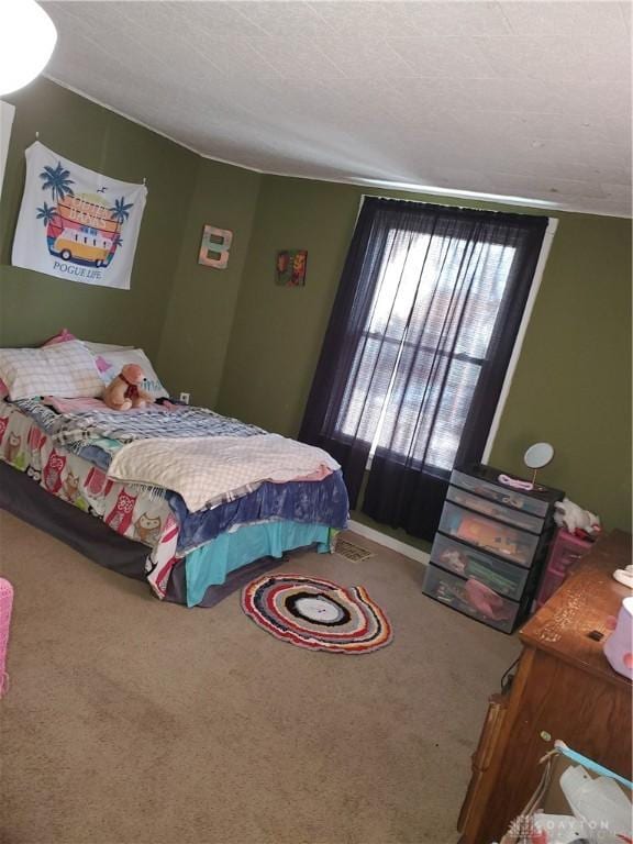 carpeted bedroom featuring a textured ceiling