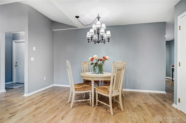 dining area featuring a chandelier and light wood-type flooring