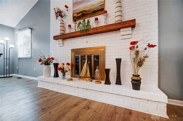 room details with hardwood / wood-style flooring and a brick fireplace