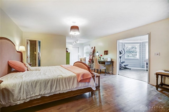 bedroom featuring ensuite bathroom and dark wood-type flooring