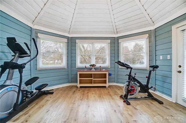 workout room featuring wood ceiling, a healthy amount of sunlight, vaulted ceiling, and wood-type flooring