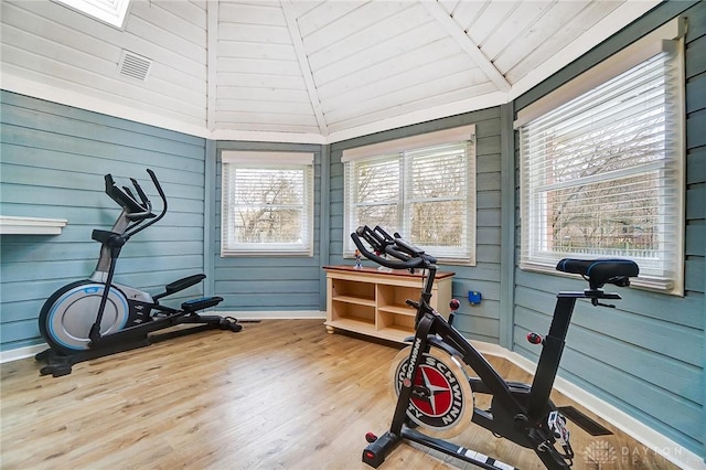 workout room with lofted ceiling, hardwood / wood-style floors, and wooden ceiling