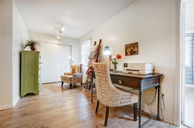 sitting room with light hardwood / wood-style floors and a textured ceiling