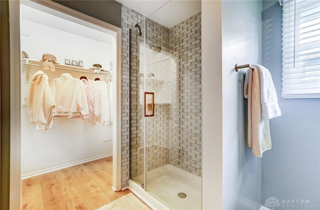 bathroom featuring a shower with door and wood-type flooring