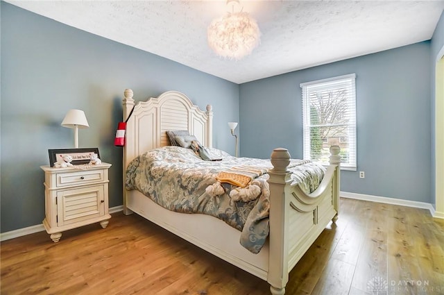 bedroom featuring hardwood / wood-style floors and a textured ceiling