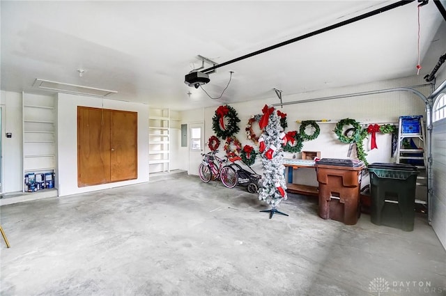 garage featuring a garage door opener and electric panel