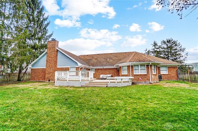 back of property featuring a wooden deck, a yard, and an outdoor hangout area