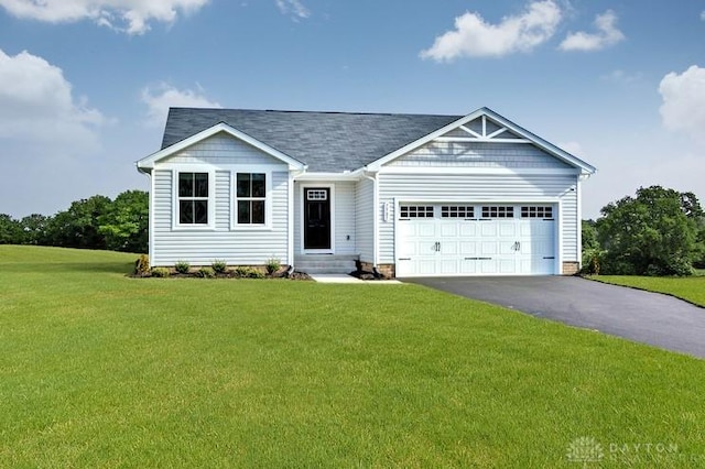 view of front of home with a garage and a front lawn