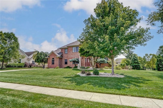 view of front of property with brick siding and a front yard