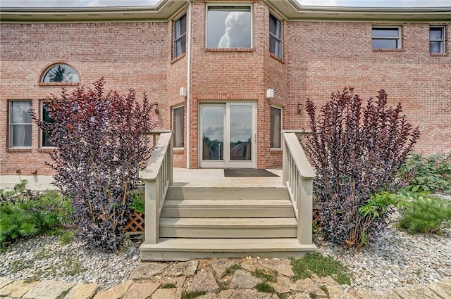 doorway to property with brick siding