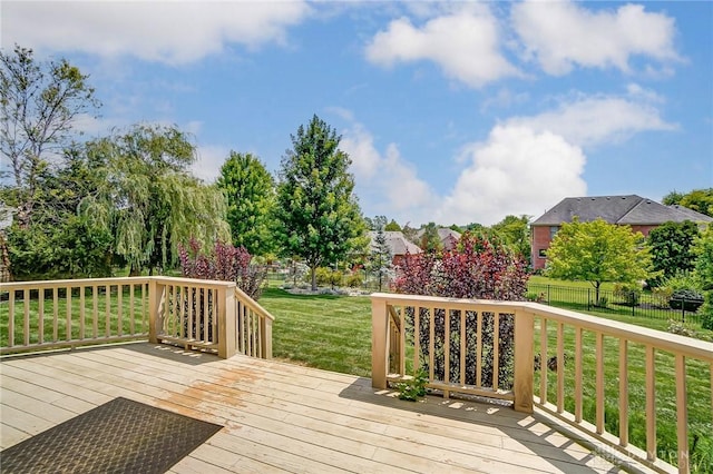 deck featuring a yard and fence