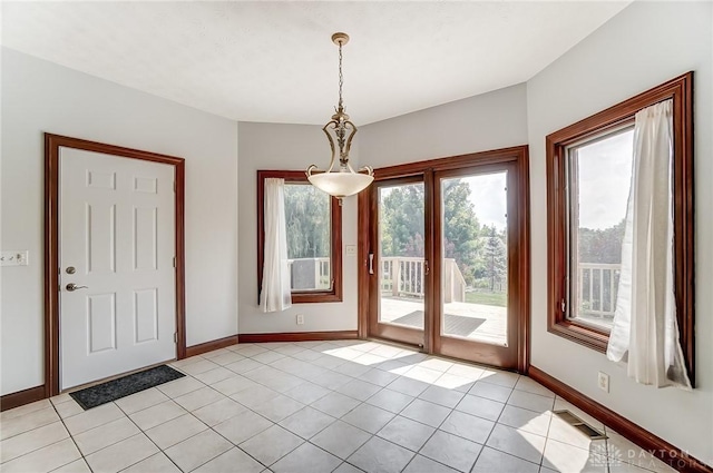 doorway with light tile patterned floors, baseboards, and visible vents