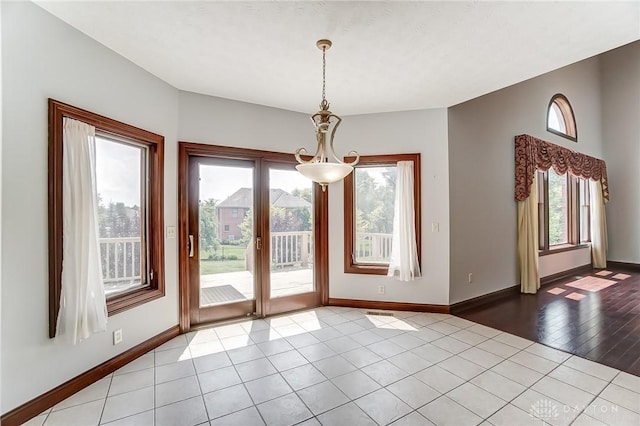 interior space with light tile patterned flooring and baseboards