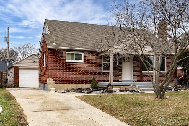 view of front of property featuring an outbuilding, a garage, and a front lawn