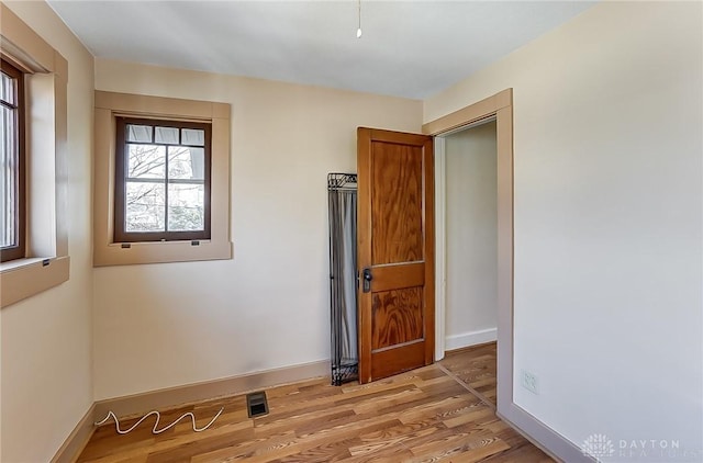 unfurnished room with light wood-type flooring