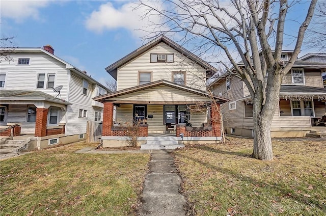 view of front of house with a front yard and covered porch